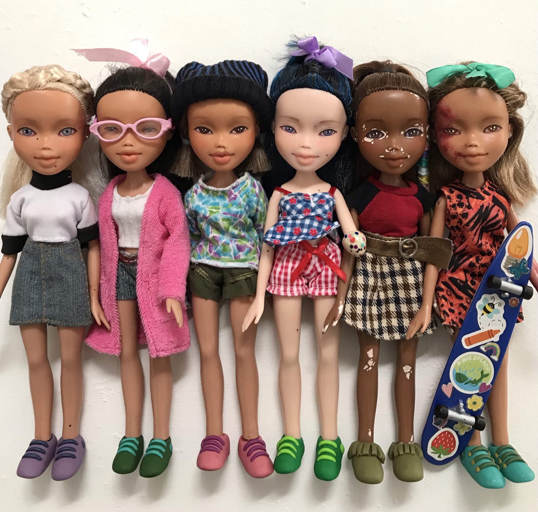 Six Dolls for Everyone characters lined up — diverse skin tones, styles, and personalities