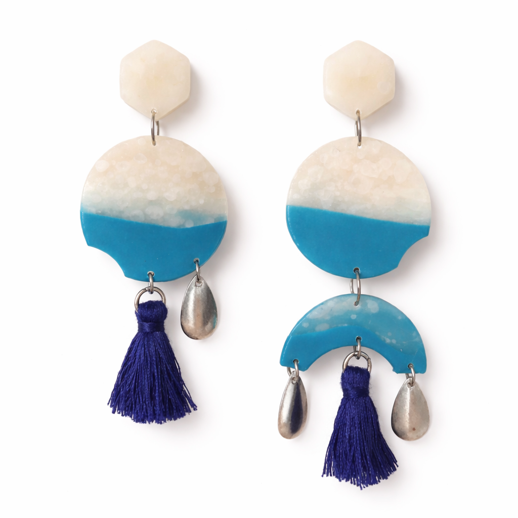 Blue resin geometric earrings with navy tassel — product shot on white background