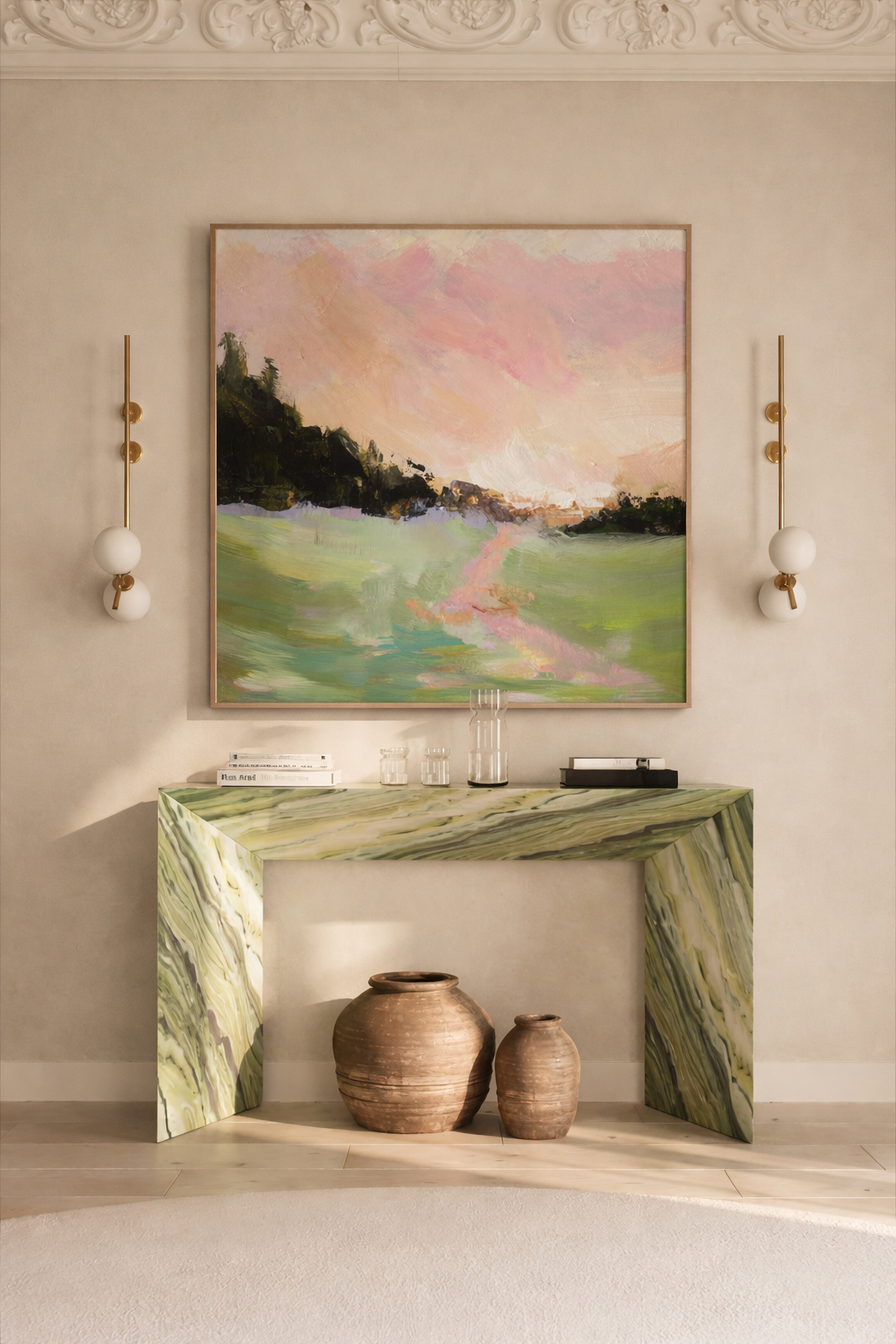 Pink gestural landscape installed above a sculptural green marble console table in a sun-lit room