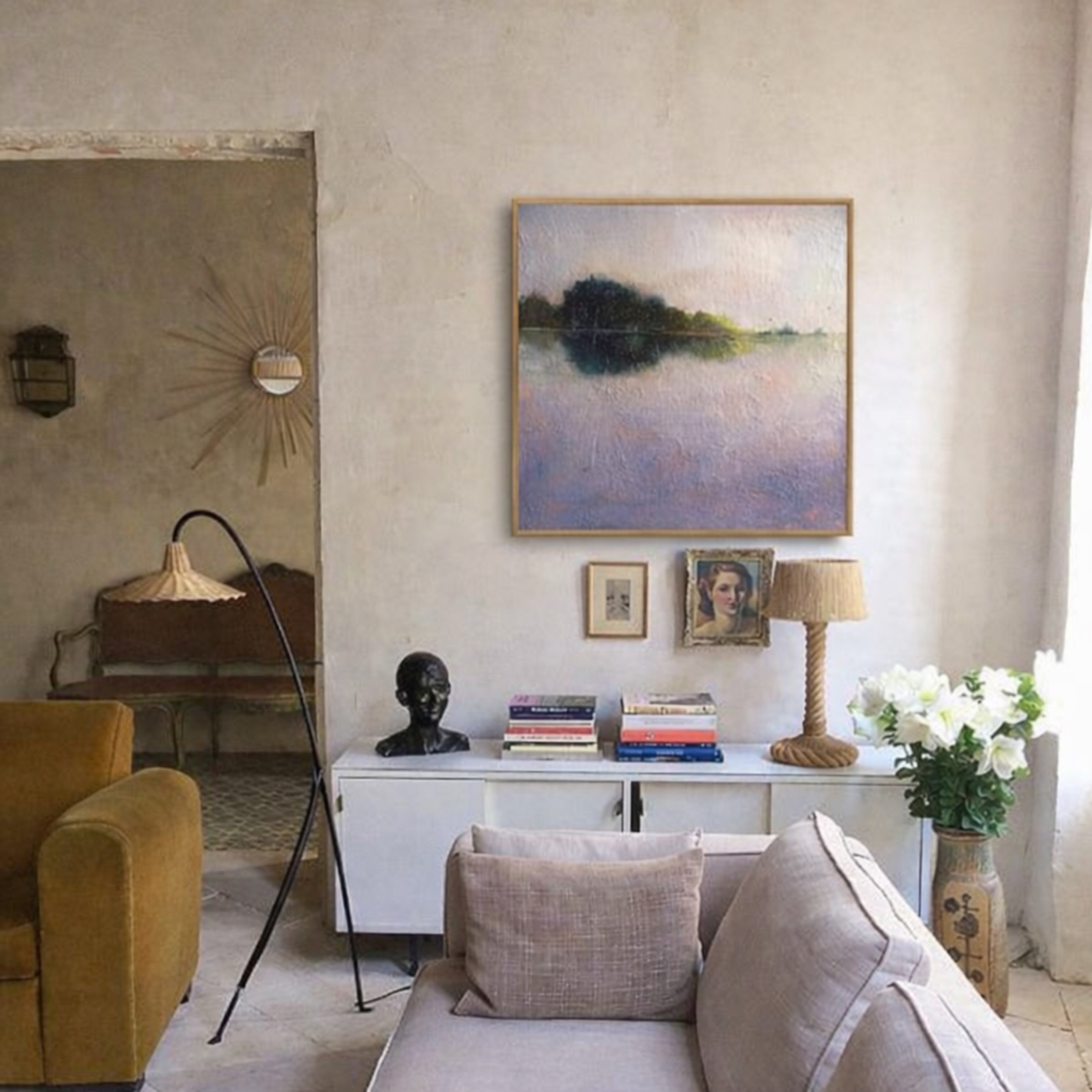Purple lake painting hanging in a warm French provincial living room with eclectic found objects