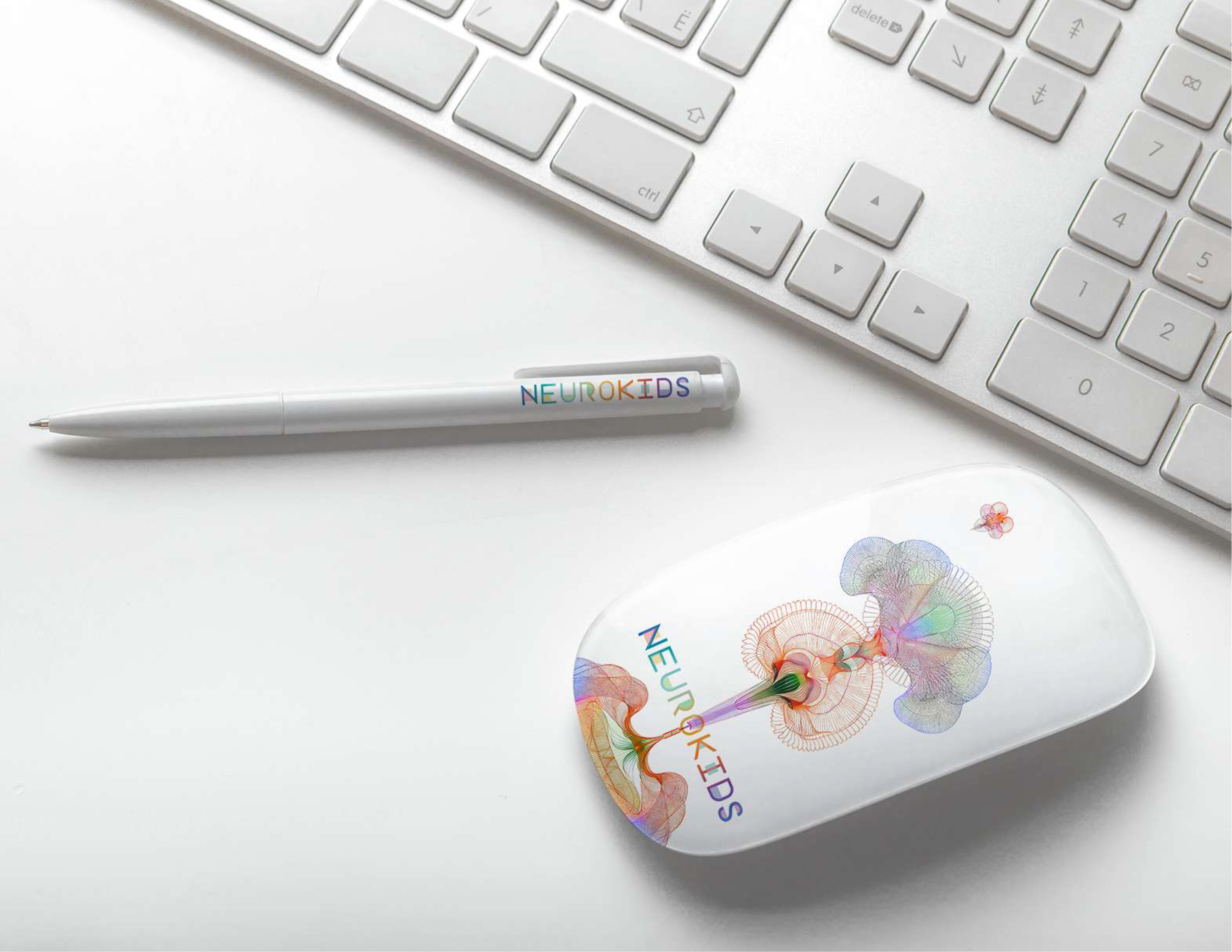 Neurokids 2025 branded tech accessories — pen and magic mouse on desk